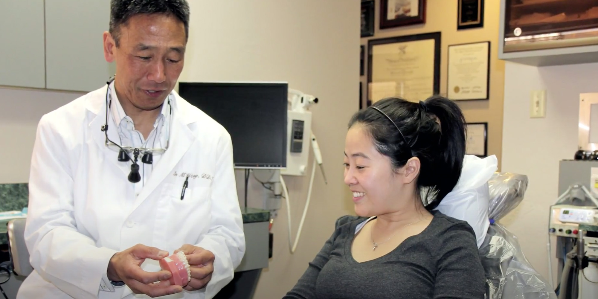 Dr. Les Wong Showing A Dental Patient A Full Arch Prosthesis